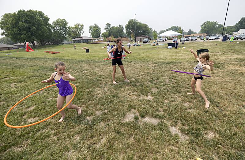 Kaydence Lahey (left), 7, Jazzie Pinzon and Sutton Venier break out their best Hula Hooping skills Thursday, June 15, 2023 during the SPARK Camp in Dixon.