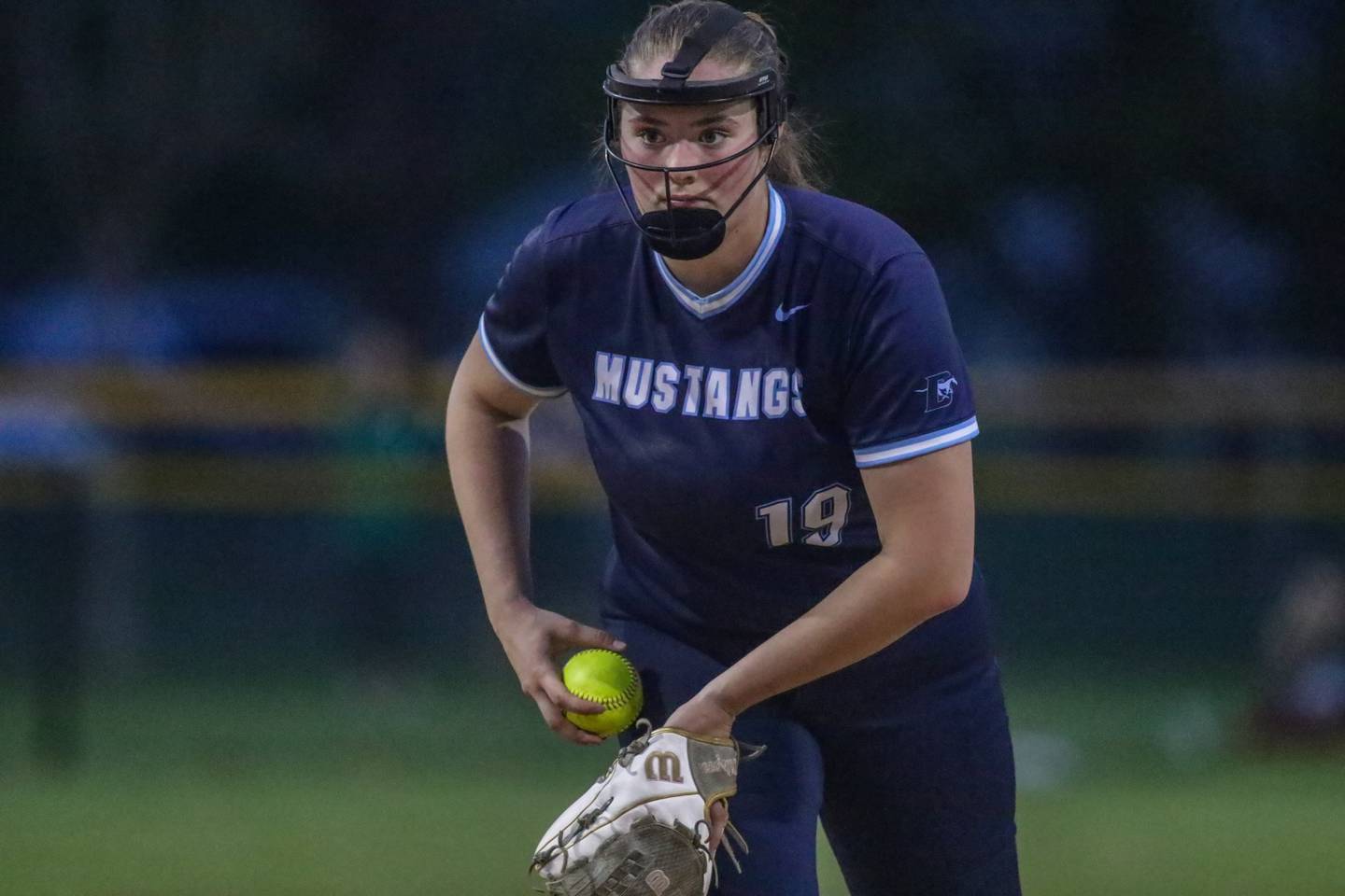 Downers Grove South's Ella Cushing (19) focuses on the plate during varsity softball game between Downers Grove South at Downers Grove North.  May 11, 2023.