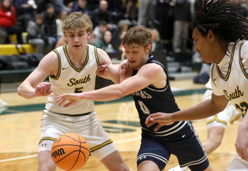 Crystal Lake South's Carson Trivellini battles for a loose ball with Cary-Grove's Brandon Freund during a Fox Valley Conference boys basketball game on Friday, Jan. 23, 2026, at Crystal Lake South High School.