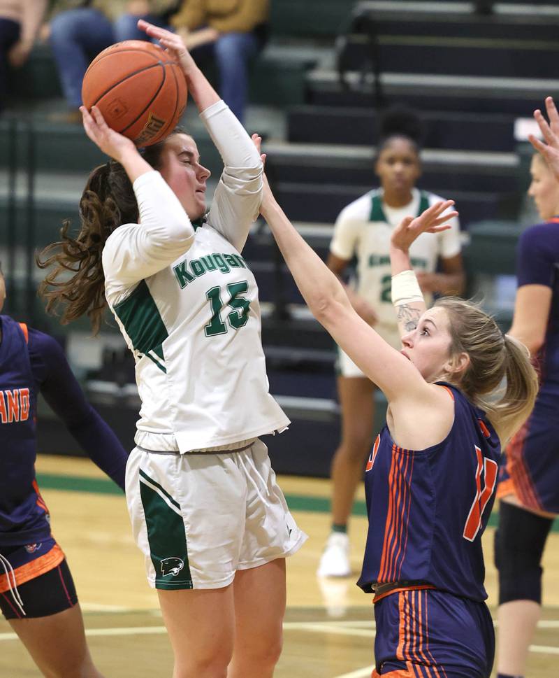 Kishwaukee College's Emily Gilbert shoots over Highland Community College's Talena Rogers during their game Thursday, Jan. 11, 2024, at Kishwaukee College in Malta.