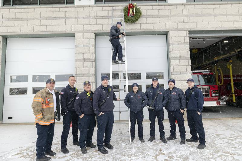 Dixon City and Rural firefighters remind locals to keep the wreath red this holiday season Monday, Dec. 2, 2024. Pictured: Dustin Dahlstrom (left), Jason Hemmer, Matt Hey, Tanner Cole, on ladder Tristan Ramirez. Nate Robles, Dylan Fisher, Nate McCoy and Mark Palacz.