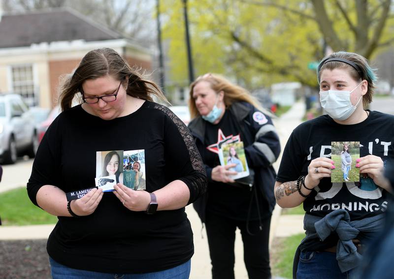 Friends and coworkers of Melissa Lamesch hold photos of her and her unborn baby as they stand in front of the Ogle County Judicial Center following a 2022 bond reduction hearing for Matthew Plote who is accused of their 2020 murders. Pictured, left to right, are: Rachel Sitkiewicz, Kiki Sitkiewicz, and Bridget Burke. Rachel Sitkiewicz served as an EMT with Lamesch.