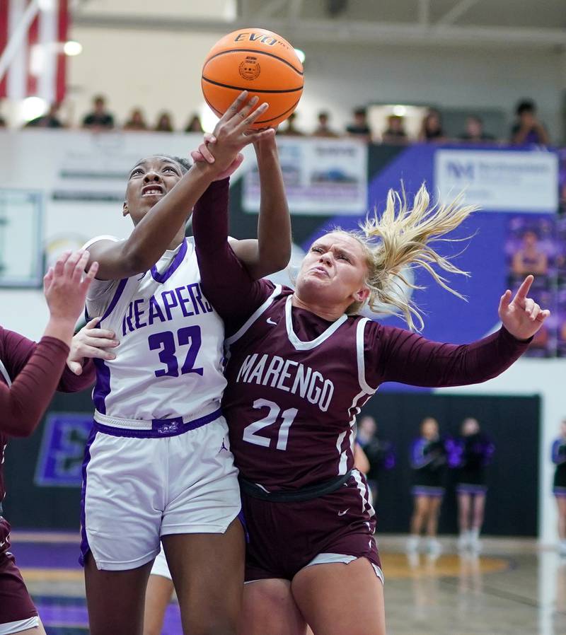 Plano's Naylah Mathews (32) and Marengo’s Mia Feidt (21) fight for a rebound during a basketball game at Plano High School on Wednesday, January 29, 2025.