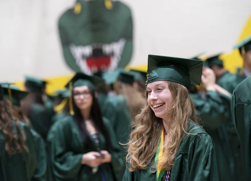 Marissa Baietto laughs with classmates while lining up in the gym before a graduation ceremony for the class of 2022 on Saturday, May 14, 2022, at Crystal Lake South High School in Crystal Lake.