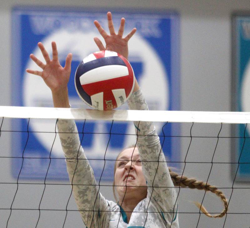 Woodstock North’s Clara Klasek blocks against Richmond-Burton in varsity volleyball at Woodstock Monday night.