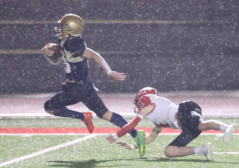 Polo's Mercer Mumford sprints to the end zone after avoiding a tackle from Amboy/LaMoille/Ohio's Colt McCoy during the 8-man I8FA championship game on Friday, Nov. 21, 2025 at April Zorn Memorial Stadium in Monmouth.
