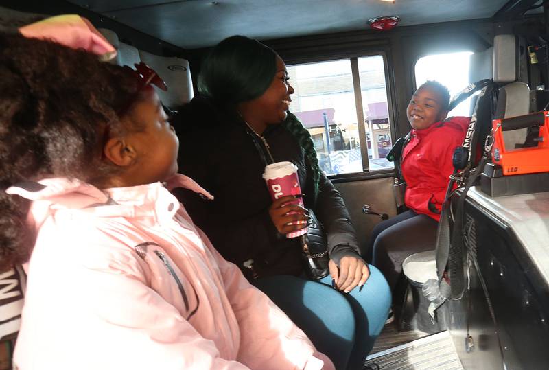 (From left) Loyalty Burgess, her mom Christina and her brother Superior ride in a La Salle firetruck during the annual Miracle on First Street event on Saturday, Dec. 7, 2024 downtown La Salle. Miracle on First Street began in 2009 and has continued to become a holiday tradition for families.