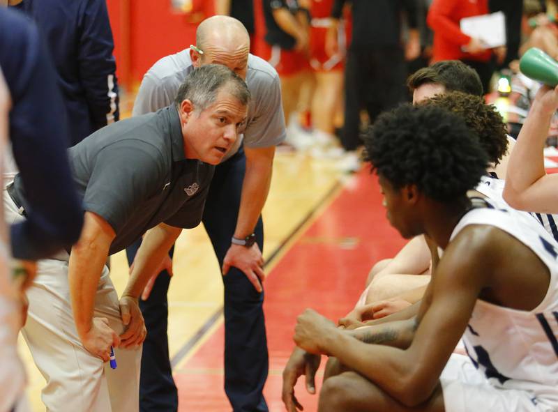 Oswego East coach Ryan Velasquez talks to the team during a timeout at the Hinsdale Central Holiday Classic championship game between Oswego East and Hinsdale Central high schools on Thursday, Dec. 29, 2022 in Hinsdale, IL.