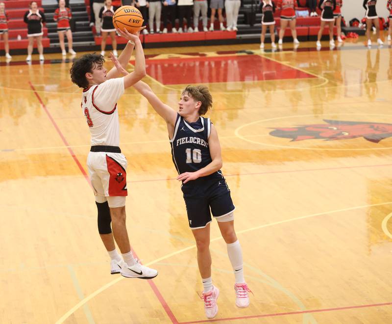 Hall's Noah Plym shoots a jump shot over Fieldcrest's Kash Klendworth during the Colmone Classic on Friday, Dec. 12, 2025 at Hall High School.