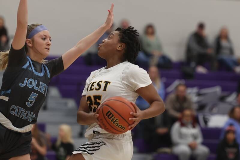 Joliet West’s Mariah Shelton drives in for the basket against Joliet Catholic in the WJOL Basketball Tournament at Joliet Junior College Event Center on Monday