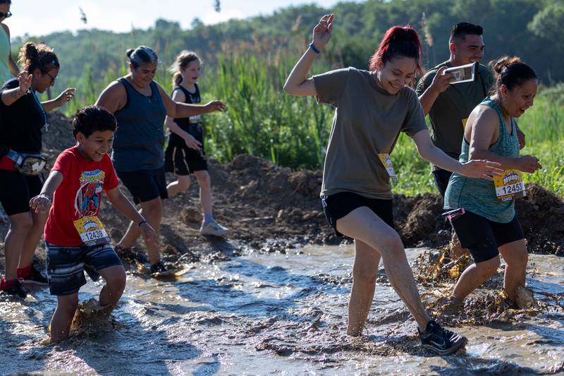 Participates of the 2025 Muddy Dash run in mud on Saturday, June 28, 2025 at Fox Valley Off Road in Utica.