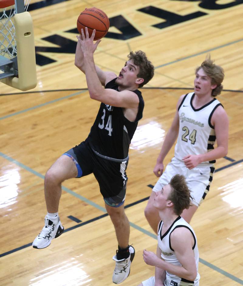 Kaneland's Parker Violett gets to the basket ahead of Sycamore's Lucas Winburn as he goes to the basket during their game Friday, Feb. 10, 2023, at Sycamore High School.