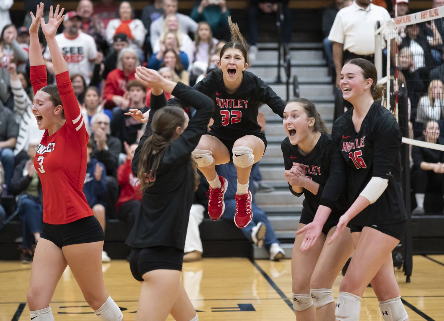 Huntley's Izzy Whitehouse, center, jumps in the air as she celebrates with teammates after winning against Libertyville at the Class 4A Sectional girls volleyball final on Thursday, November 7, 2024 at McHenry High School. Ryan Rayburn for Shaw Local