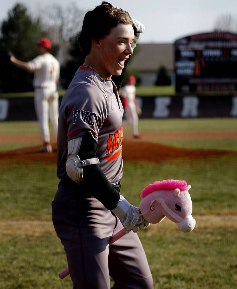 McHenry’s Carver Cohn celebrates his grand slam home run during a Fox Valley Conference baseball game against Huntley on Friday, April 11, 2025, at Huntley High School.