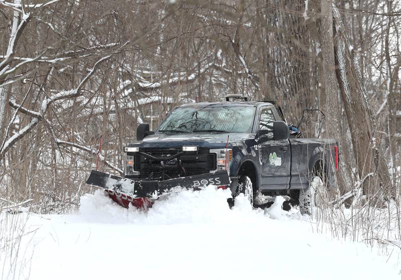 A DeKalb Park District snowplow clears the walking path Monday, March 16, 2026, at County Farm Woods Park in DeKalb. A March snowfall covered DeKalb County in about six inches of the white stuff Sunday night into Monday.