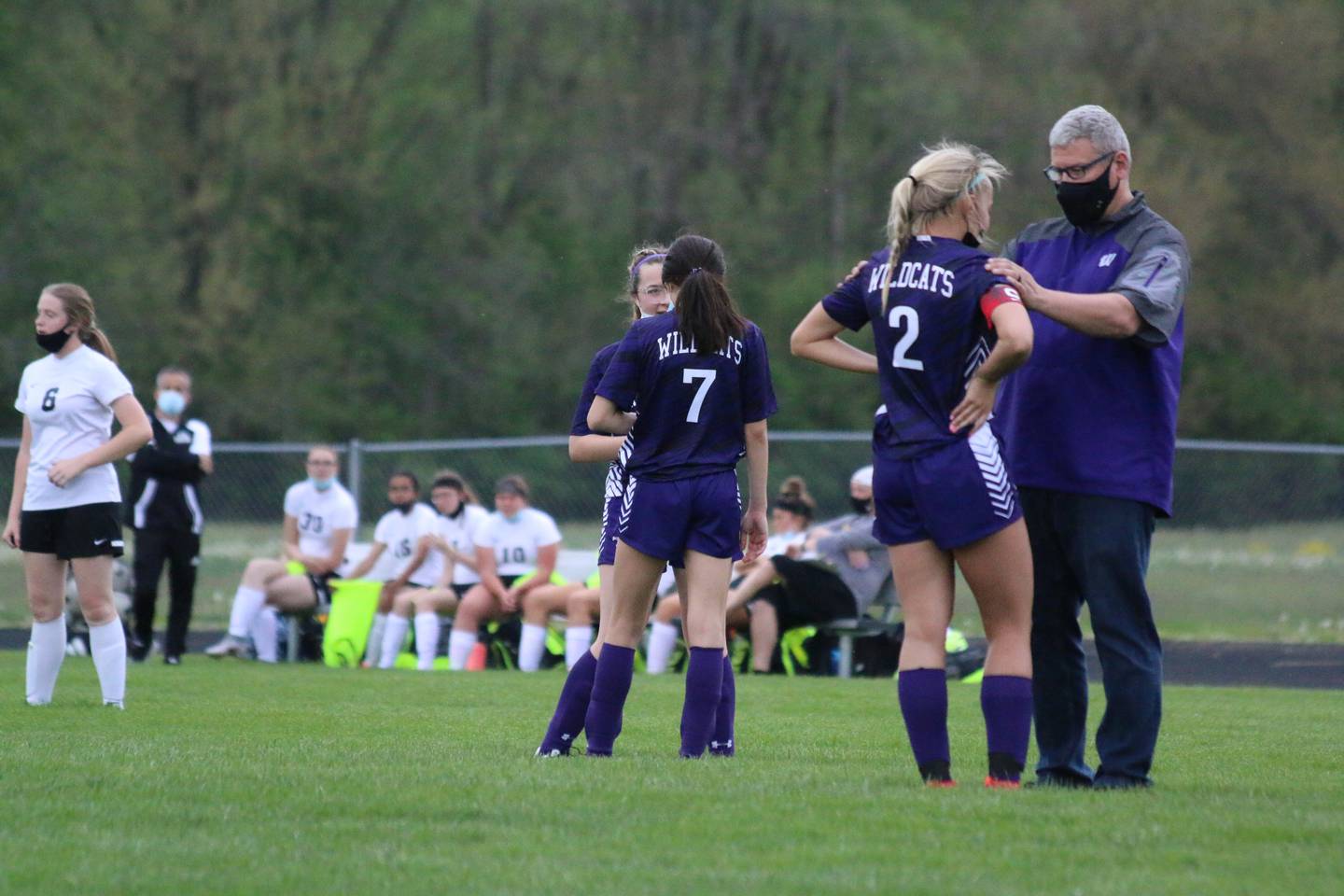 Travis Ivanoff (right) coaching the Wilmington girls soccer team during a game.