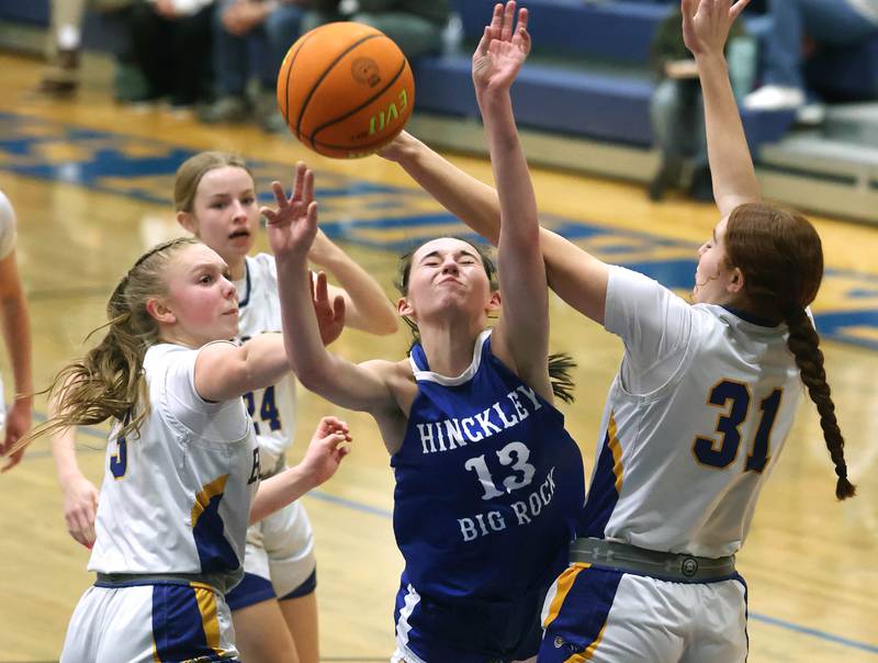 Hinckley-Big Rock's Mia Cotton forces up a shot between Somonauk/Leland’s Macey Kinney (left) and Ella Roberts during their game Thursday, Jan. 15, 2026, at Somonauk High School.
