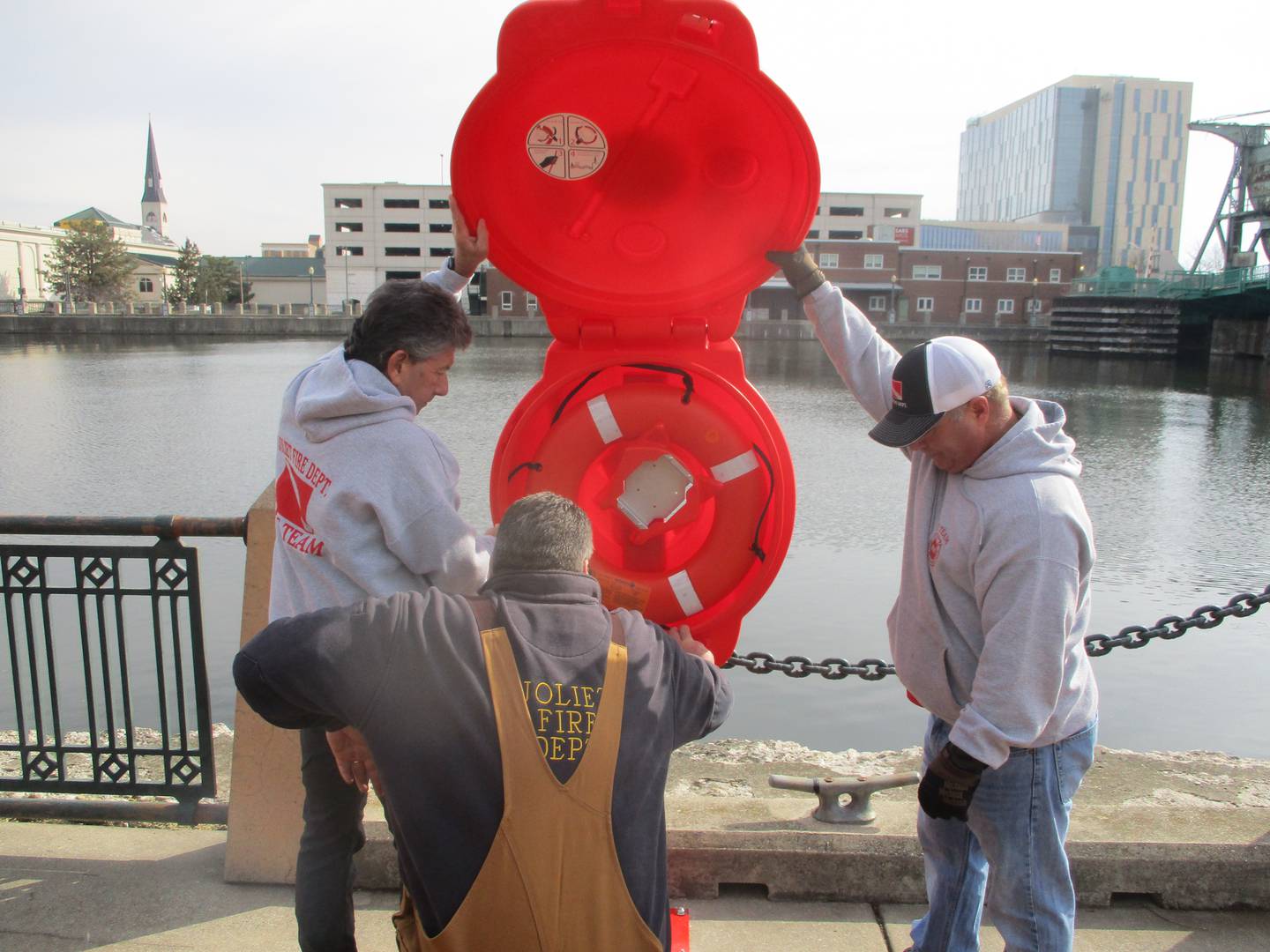Joliet firefighters install one of the first life saver boxes in Billie Limacher Bicentennial Park along the Des Plaines River in Joliet. From left are retired Battalion Chief Ron Fox, Capt. Nick Carbaugh and Battalion Chief Jim Batusich.