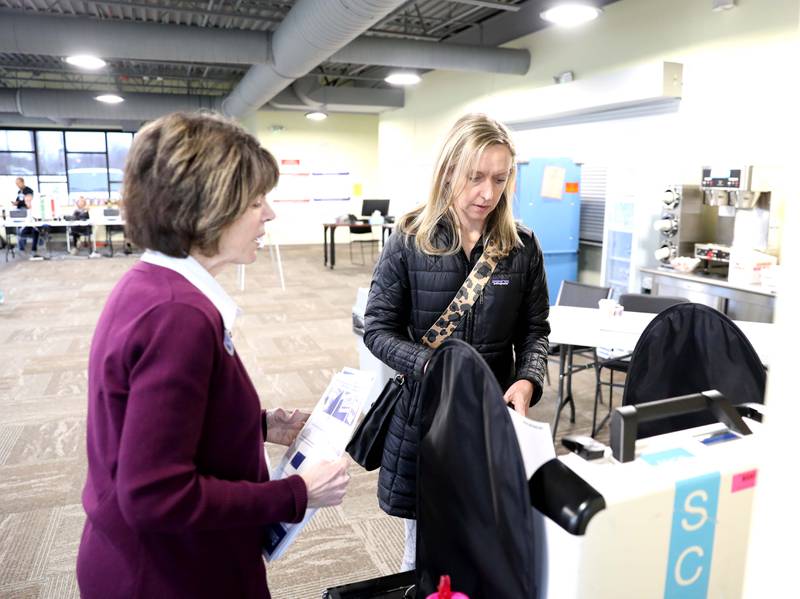 Election Judge Sue Khalaieff helps voter Natalie Wilson of Downers Grove during the Consolidated Election at the Downers Grove Township offices polling place on Tuesday, April 3. 2023.