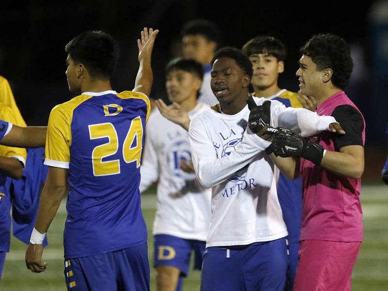 Chicago De La Salle's Jahir Anaya his heads back by teammates after he receive a red card for taunting Prairie Ridge fans after the clock expired in an IHSA Class 2A state semifinal soccer match on Friday, Nov. 8, 2024, at Hoffman Estates High School.