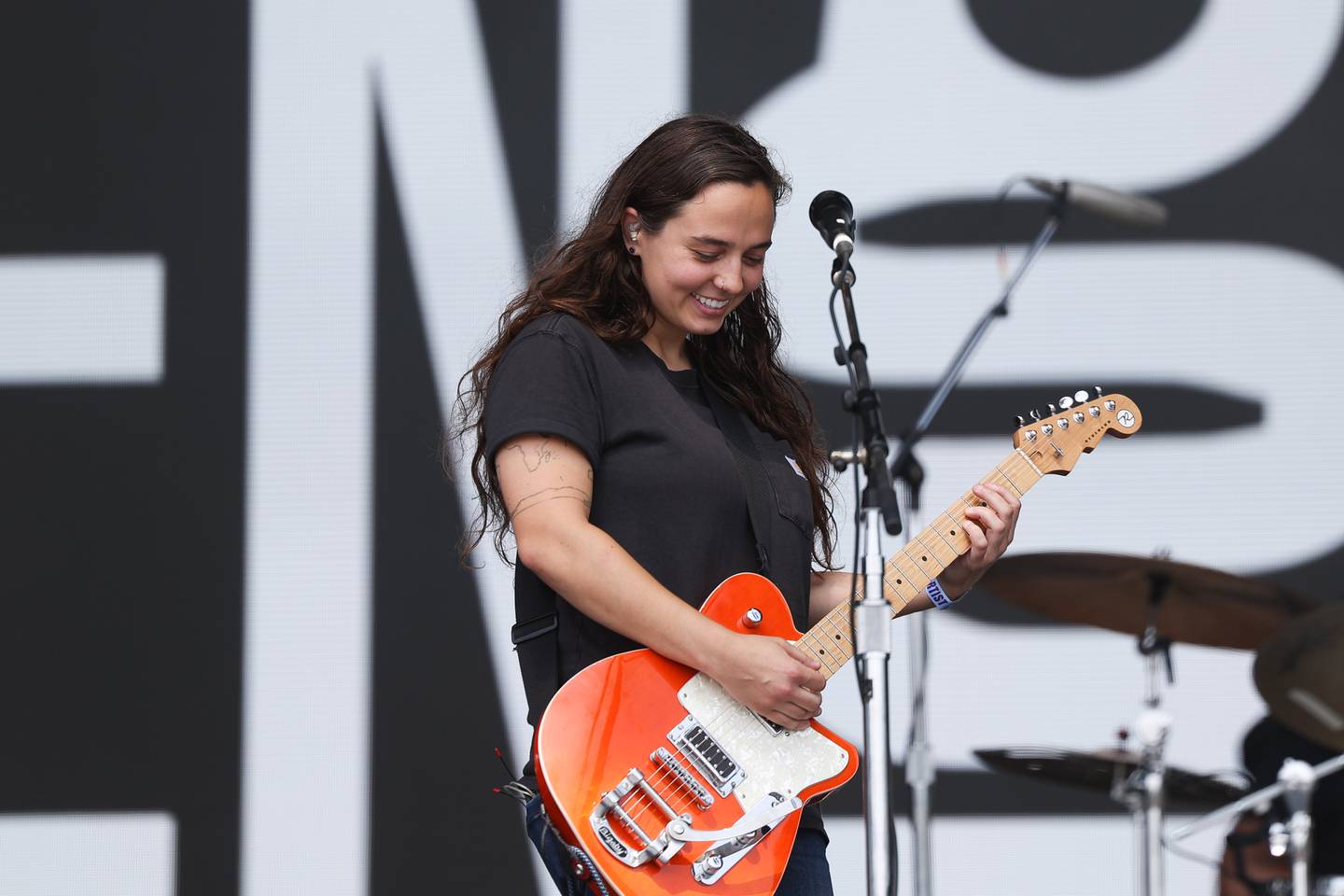 Lead singer Deanna Belos smiles during Sincere Engineer’s opening song on the Bud Light stage at Lollapalooza on Friday, Aug. 4 in Chicago.