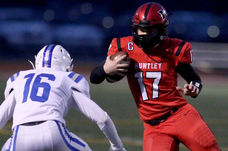 Huntley quarterback Bruno Bosman tries to evade Burlington Central's Nathan Majewski during their football game at Huntley High School on Friday, March 26, 2021 in Huntley.