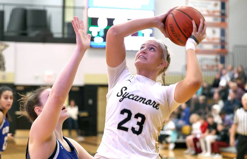 Sycamore's Evyn Carrier shoots over Geneva's Cassidy Arni during their game Monday, Nov. 14, 2022, at Sycamore High School.