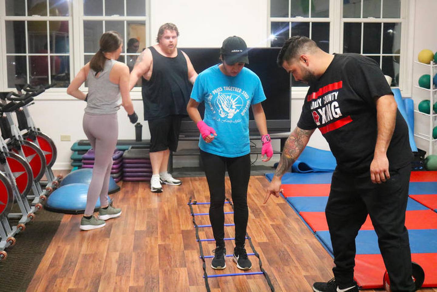 Nick Galvan (right) provides instruction to his cousin Bianca Guardiola during a recent boxing class held at Resolve Fitness & Health and its Diamond location.