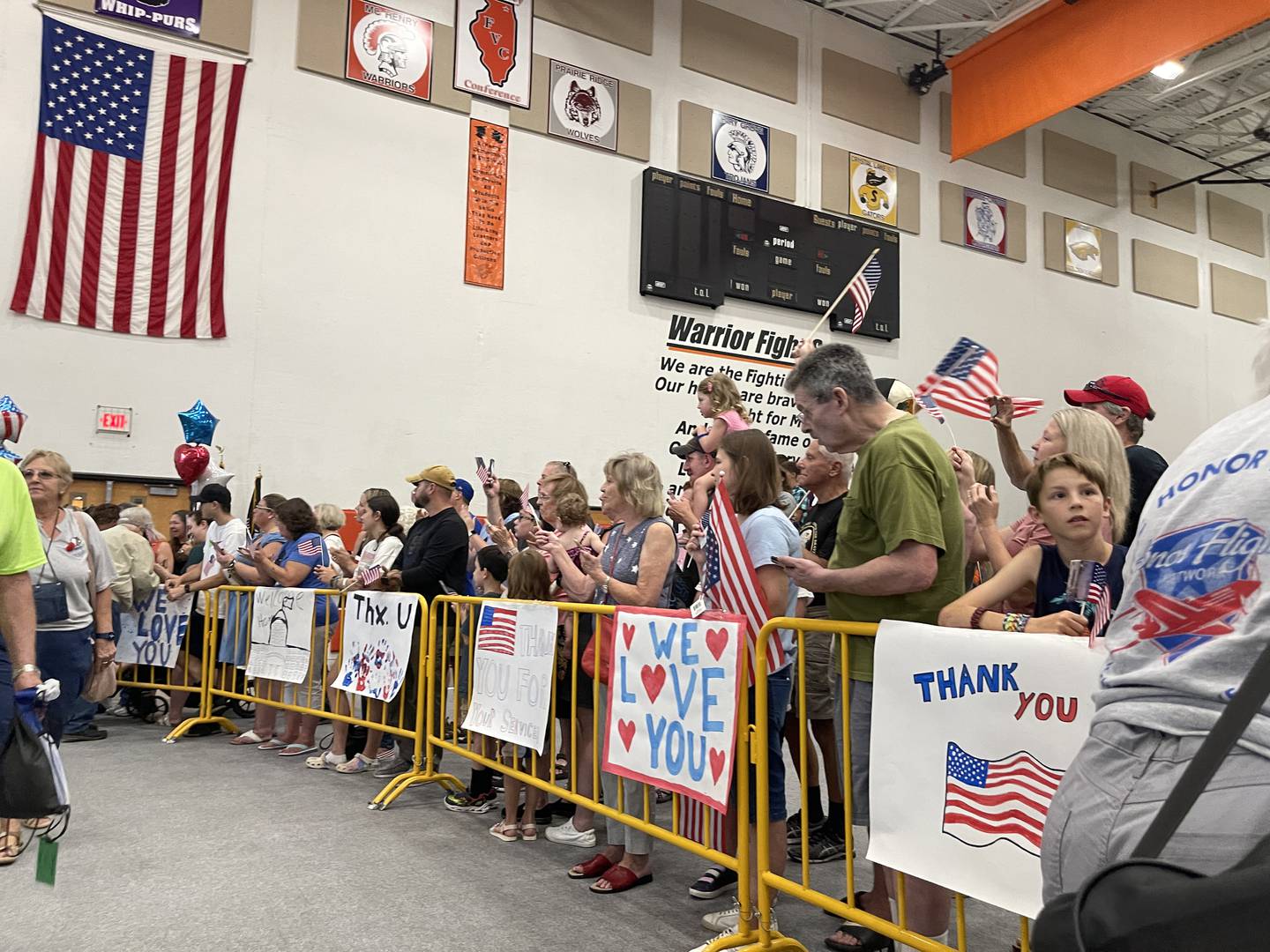 Attendees wait local veterans to arrive on Sunday, Aug. 28, 2022 at McHenry High School. More than 50 veterans who went on the Honor Flight over the weekend to visit war memorials in Washington D.C. and were welcomed home at McHenry High School.