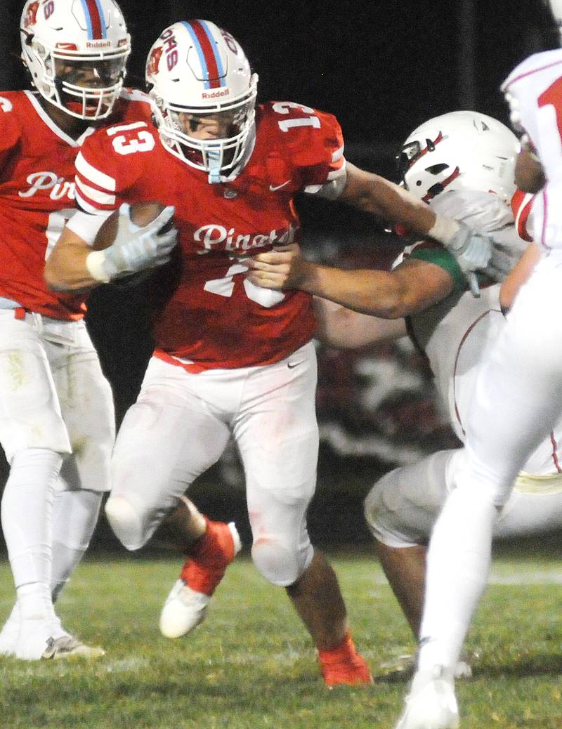 Ottawa's Ryder Miller (13) evades the tackle of Streator's Aidan Stevens at King Field on Friday, Sept. 1, 2023.