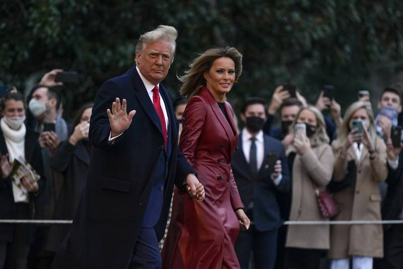 President Donald Trump and first lady Melania Trump walk on the South Lawn of the White House in Washington, Saturday, Dec. 5, 2020, before boarding Marine One for a short trip to Andrews Air Force Base, Md. Trump is en route to Georgia for a rally for U.S. Senate candidates David Perdue and Kelly Loeffler.