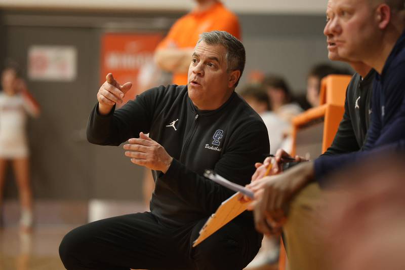 Oswego East head coach Ryan Velasquez talks to an assistant coach during the game against Minooka on Friday, Jan. 16, 2026 in Minooka.