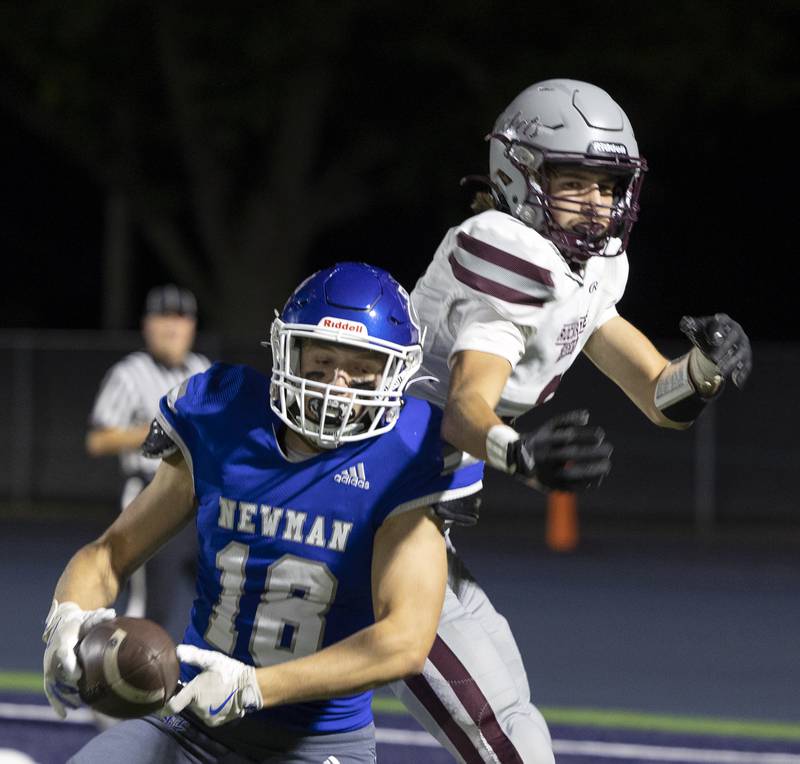 Newman’s Matthew Blackert intercepts a pass to secure the win for the Comets in front of Rockridge’s Baylen Leemans Friday, Sept. 27, 2024, in Sterling.