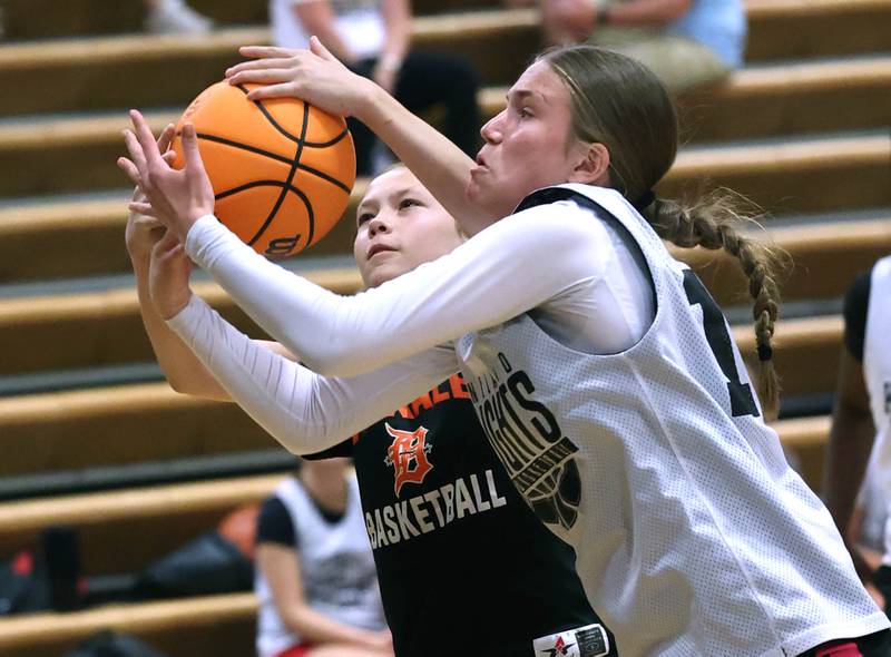 Kaneland’s Grace Brunscheen (right) and DeKalb’s Emma Craig fight for a rebound Thursday, June 12, 2025, in the Geneva High School Varsity Summer League.