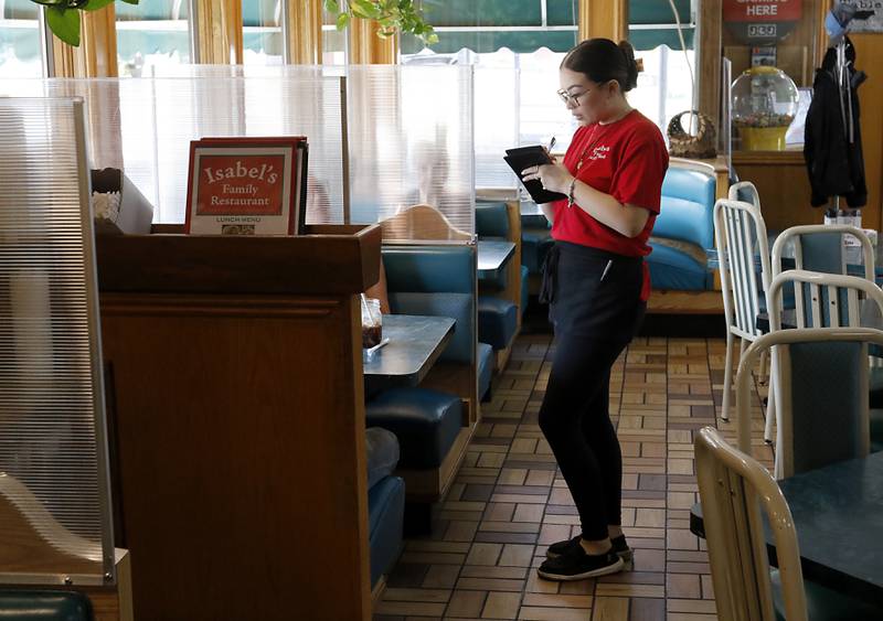 Liliana Delgado waits on a table at Isabel's Family Restaurant on Wednesday, Sept. 11, 2024. The Woodstock restaurant is celebrating its 20th year in business. Owners Mary Witt and Antonio Delgado, also own a farm near Marengo, that helps the restaurant be a farm-to-table enterprise.