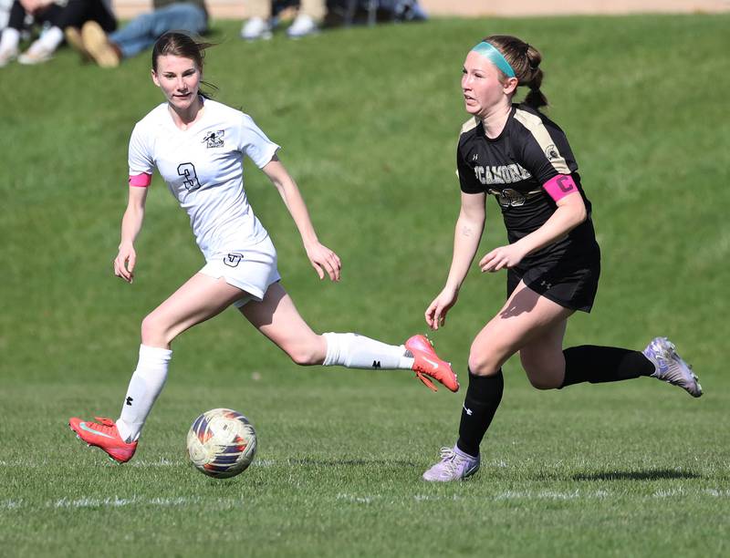 Sycamore's Cortni Kruizenga pushes the ball past Kaneland's Zoe Gannon during their game Monday, April 14, 2025, at Sycamore High School.