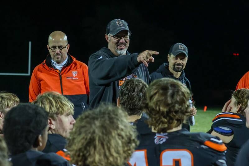 Coach of Flanagan Cornell Woodland points at player in excitement during team huddle on Friday, October 25, 2024 at Flanagan High School in Flanagan.