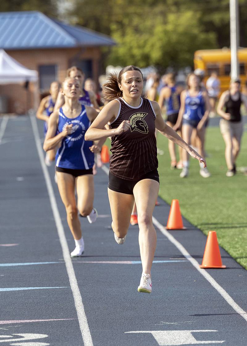 Sycamore’s Layla Janisch crosses the finish in the 800 Wednesday, May 14, 2025, during Sectionals at Sterling High School.