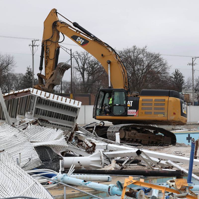 An excavator sifts through debris Tuesday, December 10, 2024, as demolition continues at Hopkins Pool in DeKalb. After the teardown is finished construction will begin on a new pool set to open in 2026.