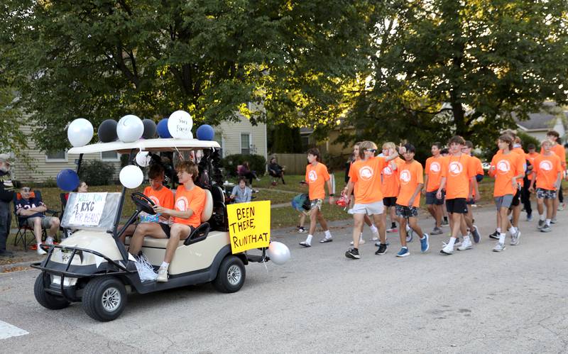 The Kaneland High School cross country team march in the  the school’s homecoming parade on Wednesday, Oct. 2, 2024 in Elburn.