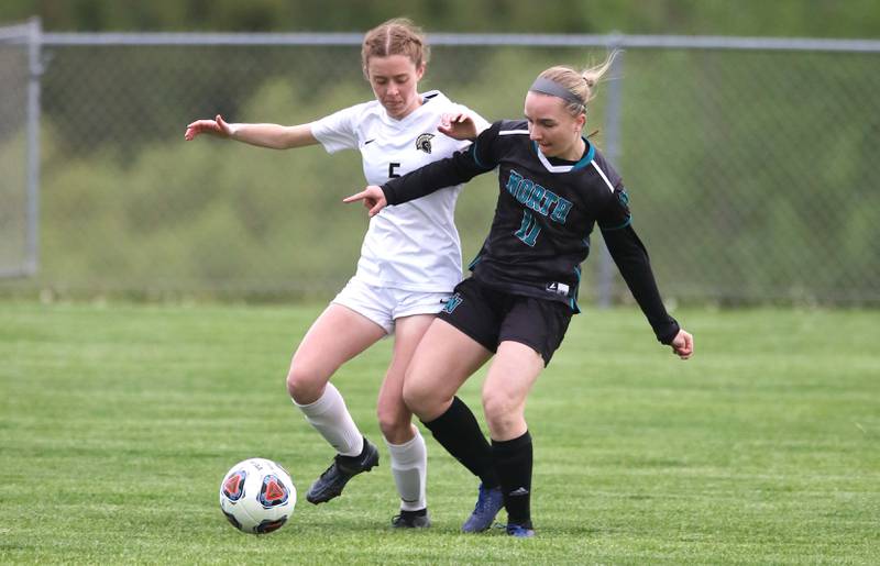 Woodstock North's Gracie Zankle holds off Sycamore's Grace Parks during their IHSA Class 2A regional game Tuesday, May 17, 2022, at Burlington Central High School.