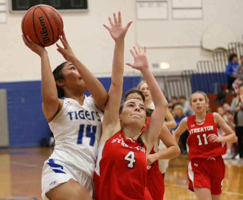 Princeton's Veronica Tirao (14) pulls p in the lane to score on a layup as Streator's Kora Lane (4) defends in the Lady Tigers Holiday Tournament on Tuesday, Nov. 15, 2022 in Princeton.