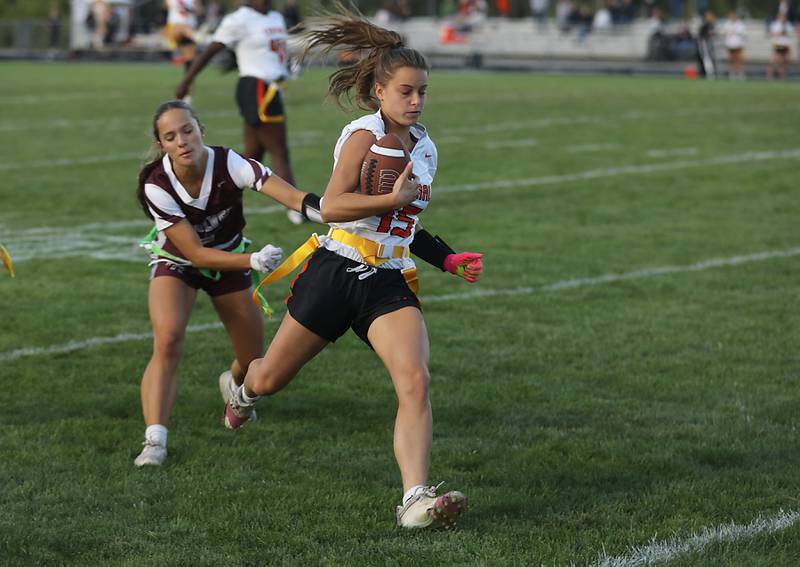 Crystal Lake Central's Emma Sieg runs for a touchdown as Prairie Ridge’s Asya Seiwert tries to grab her flag during a a Fox Valley Conference girls flag football game on Thursday, Sept. 4, 2025, at Prairie Ridge High School in Crystal Lake.