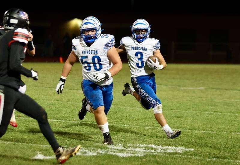 Princeton's Ace Christiansen gets a block from teammate Anthony Vujanov in Friday's game at Prophetstown. The Tigers won 61-14.