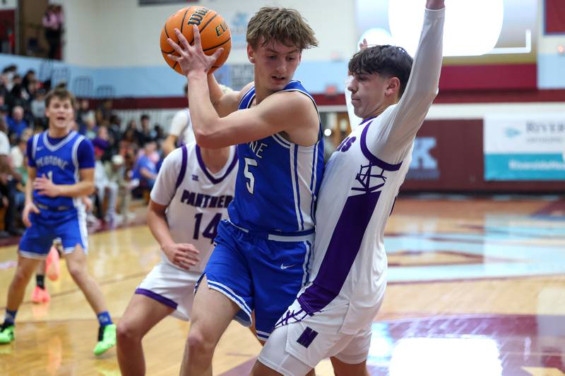 Peotone's Nate Wehrmann secures a rebound under pressure from Manteno's Cade Bechard during the Panthers' 60-49 victory over Peotone in the 75th Kankakee Holiday Tournament opening round on Friday, Dec. 26, 2025.