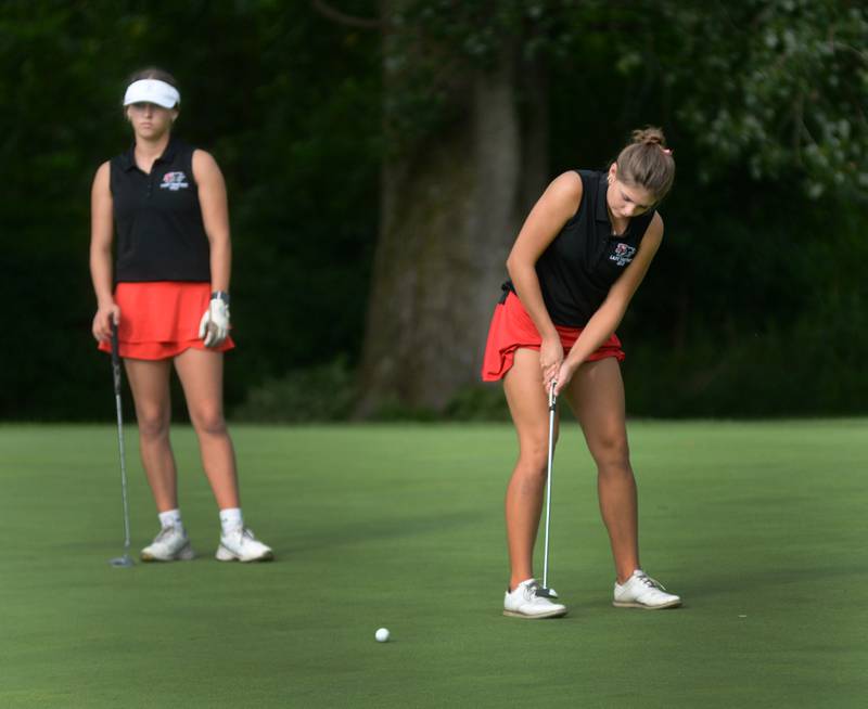 Erie-Prophetstown's Izzy Johnston (right) putts as teammate Michelle Naftzger watchs during a Monday, Aug. 18, 2025 match with Oregon High School at Silver Ridge Golf Course north of Oregon.