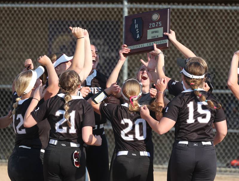 Prairie Ridge players hoist the sectional championship plaque Friday, June 6, 2025, after their Class 3A sectional final win over Crystal Lake Central at Sycamore High School.