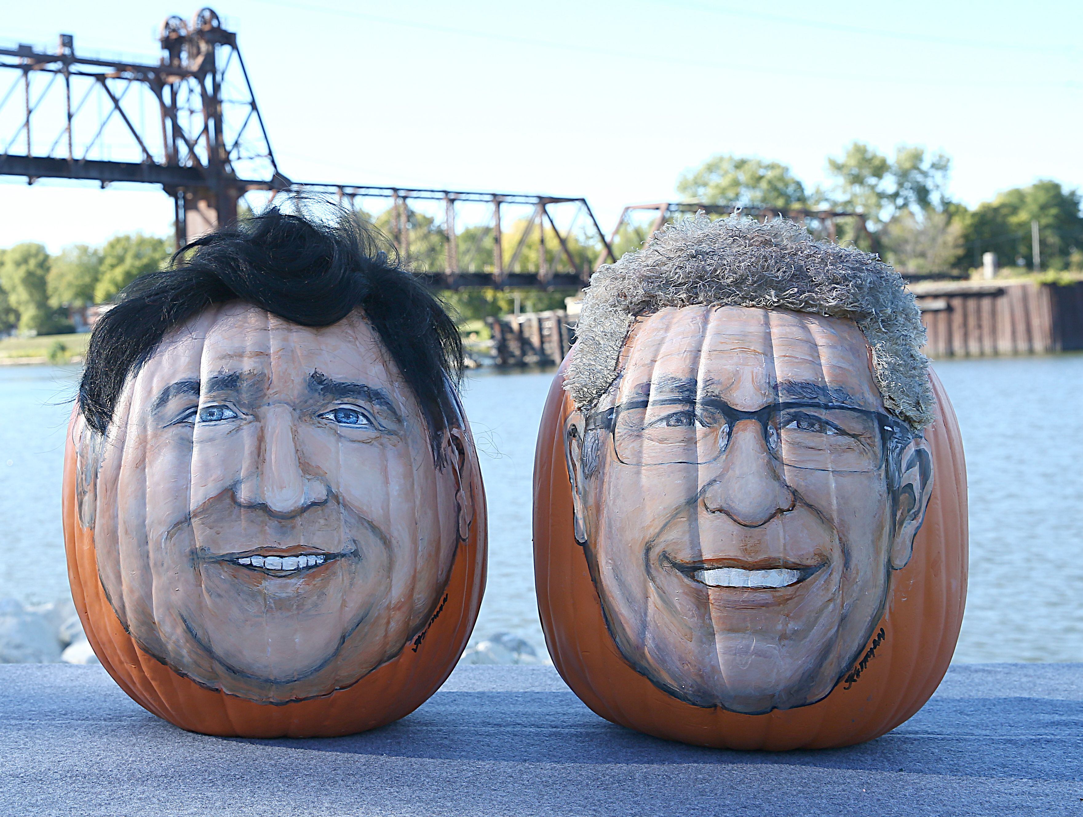 Pumpking portraying Illinois' gubernatorial candidates JB Pritzker and Darren Bailey sit side-by-side Wednesday, Sept. 28, 2022. They were created by La Salle pop artist John Kettman, who has painted politicians on pumpkins before, including his "Trumpkin Pumpkin."