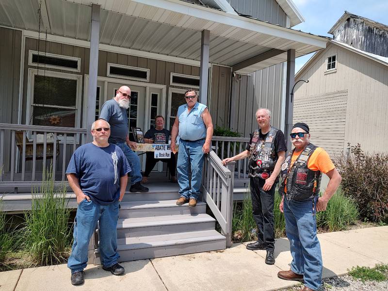 Pictured are (from left) are Open Roads members at Farm Friends having their books stamped by Kim Willman – Frank Lorang, Fred Chaffer, Bruce Littlebrant, Keith Stengler (Rolling Thunder), and Cliff Oleson.
