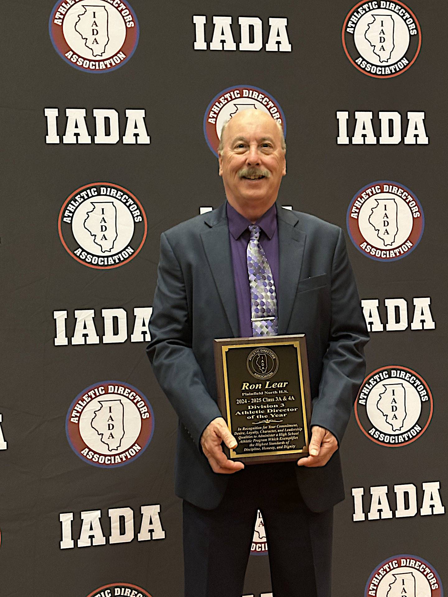 Plainfield North athletic director Ron Lear shows the plaque he earned as the IADA 2024-25 Class 3A & 4A Division 3 Athletic Director of the Year.